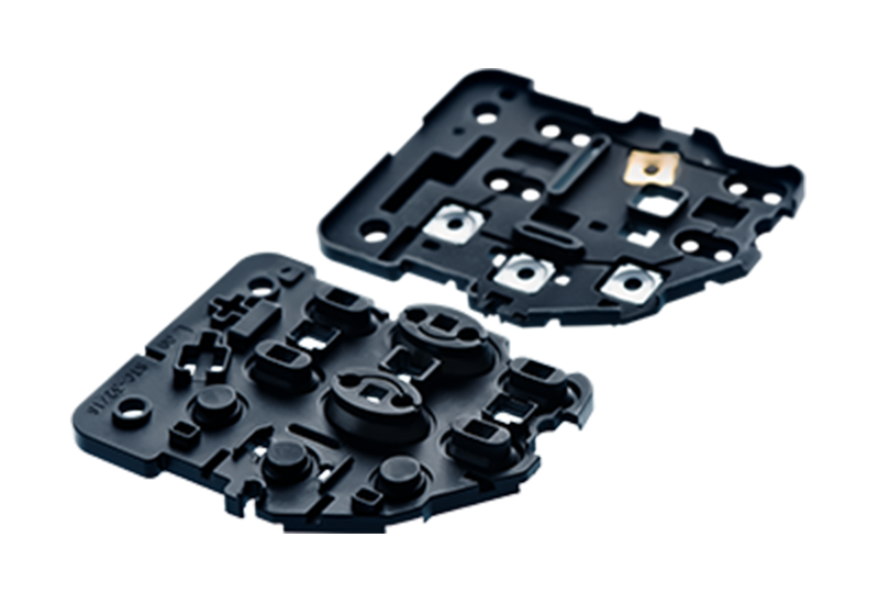 2 black silicone keypads with differently shaped domes and different electrical contacts